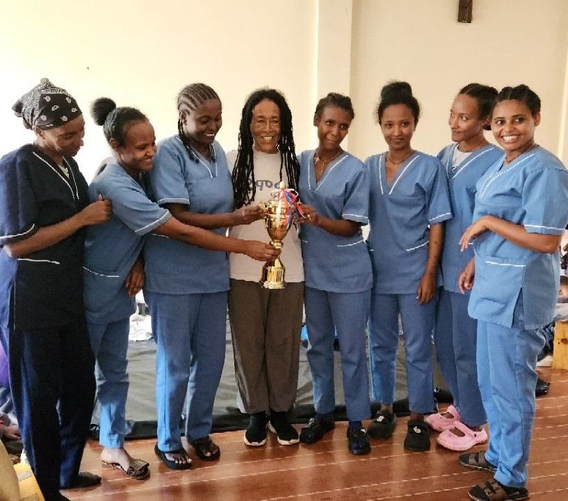 The OHWC staff team holding their award trophy