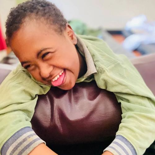 A boy laughing during a therapy session